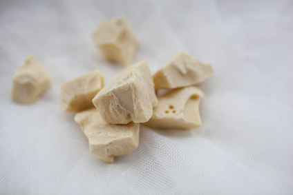 cocoa butter lying on white table Unrefined Cocoa Butter