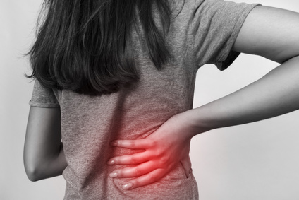 Pretty woman suffers from backache. Black and white with red accent. Pain concept close-up Injury Recovery Formula